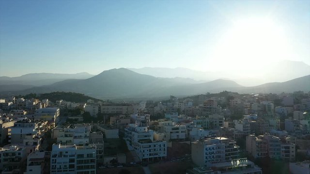 Aerial view of city Agios Nikolaos on a cloudy day. City by the sea. Aerial video of Agios Nikolaos in Crete GREECE