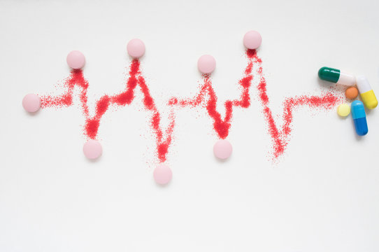 concept of medical care, heart rate, cardiograms, ECG and pills