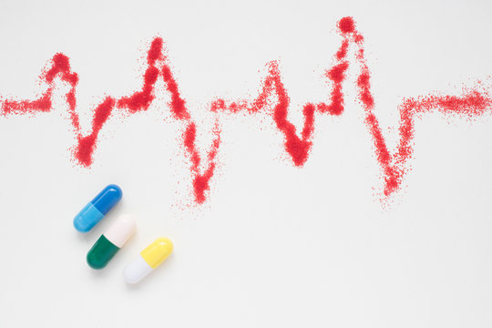 concept of medical care, heart rate, cardiograms, ECG and pills