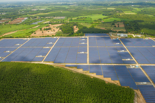 Aerial view of the solar panel farm when the sunrise and the sun shines beautifully