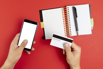 Hands holding a notebook and phone mock up