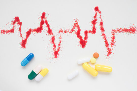 concept of medical care, heart rate, cardiograms, ECG and pills