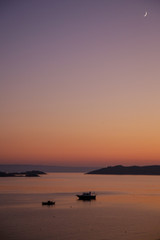 Beautiful tranquil pink and orange sunset over the sea horizon