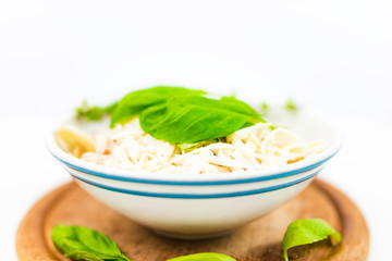 Italian pasta with tomato sauce, parmesan cheese, fresh oregano - on white background.