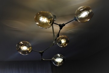 Chandelier molecule for lighting a small room. Beige shades on the ceiling chandelier.