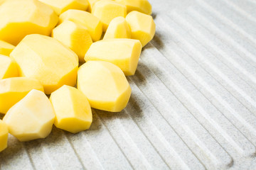 Peeled new potatoes on the sink.