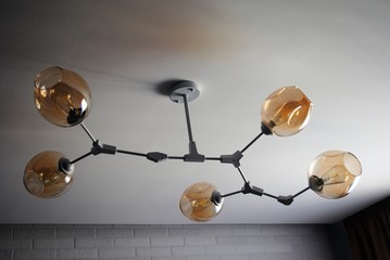 Chandelier molecule for lighting a small room. Beige shades on the ceiling chandelier.
