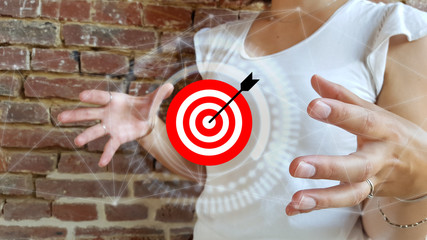 Businesswoman using digital target and arrow