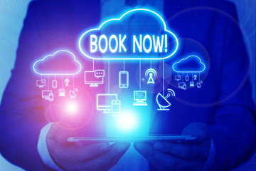 Word writing text Book Now. Business photo showcasing guaranteed to have place because you have already purchased it Male human wear formal work suit presenting presentation using smart device