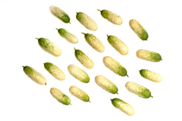 A few ripe little cucumbers over a white background.