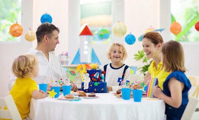 Kids space theme birthday party with cake.