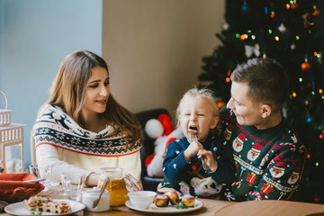 Family eat holiday breakfast on Christmas morning.