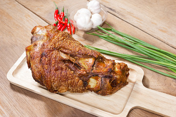 fried pork leg cooked on chopping block