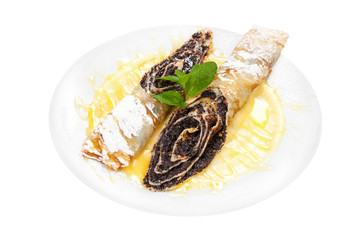 gourmet pancakes with poppy seeds, roll. On a white plate