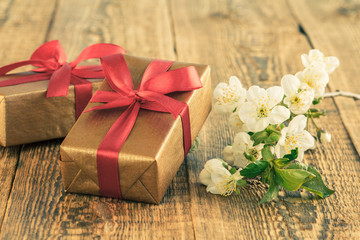 Gift boxes on wooden boards with flowers of jasmine.