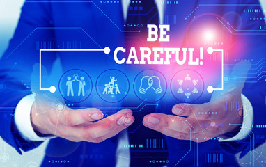 Conceptual hand writing showing Be Careful. Concept meaning making sure of avoiding potential danger mishap or harm Male wear formal suit presenting presentation smart device