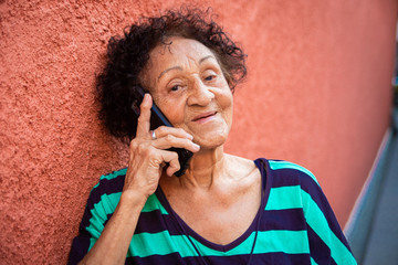 Senior brazillian reading a message on smartphone