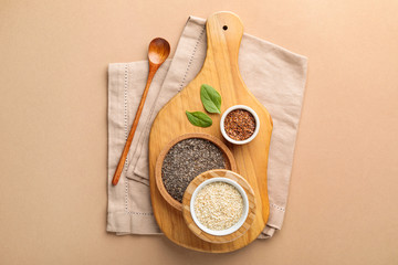 Some bowls with healthy vegan superfood cereal  on cutting board on beige background. Top view, flat lay