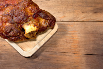 fried pork leg cooked on wood background