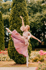 Elegant ballerina shows ballet poses in beautiful italian garden