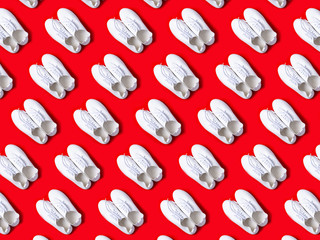 Red sneakers pattern on red background, shoes concept