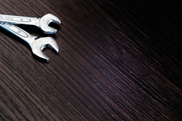 Wrenches on a dark wooden background.  Close-up.