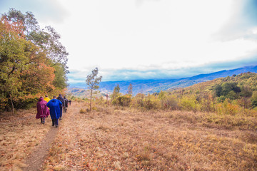 Rearview of unrecognizable people hiking on a rainy day in nature