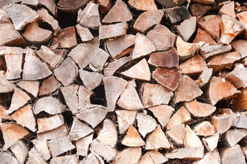 Wood logs pile background texture close up side view. Woodpile firewood fireplace concept copy space