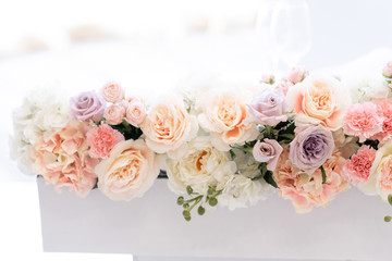 Fototapeta na wymiar Beautiful flowers on a white background. Wedding roses of different shades