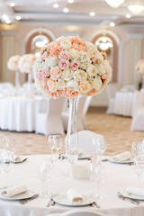 The holiday table is decorated with a large bouquet of fresh flowers