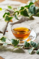 Cup of hot green tea on a wooden table