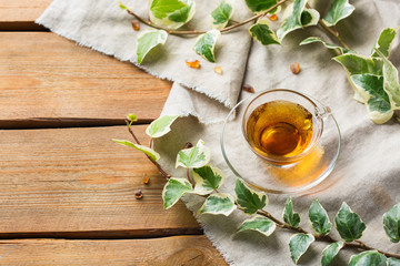 Cup of hot green tea on a wooden table