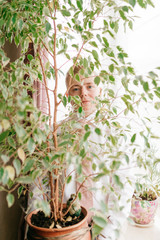 Portrait of fiance holding a pot with plant in his hands.