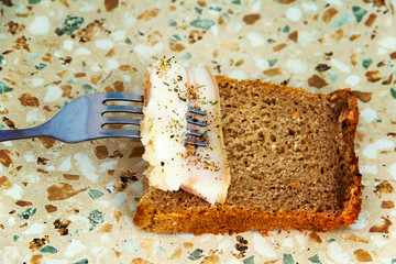 A slice of lard strung on a fork.