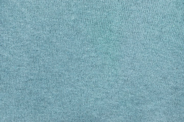 Background in the form of a porous mesh material of turquoise color