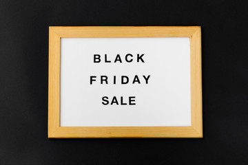 shopping and marketing concept - white magnetic board with black friday sale words