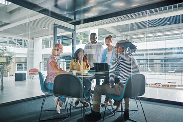 Diverse businesspeople working around a table in an office board