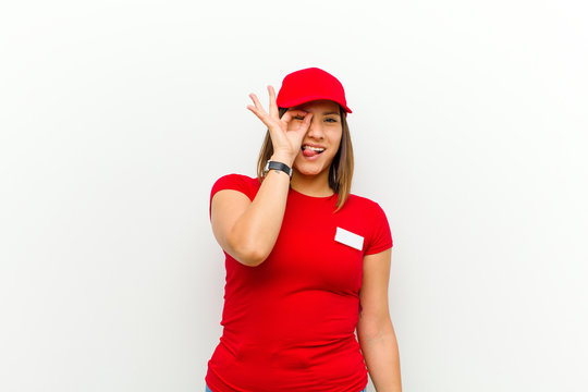 Delivery Woman Smiling Happily With Funny Face, Joking And Looking Through Peephole, Spying On Secrets Against White Background