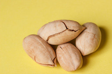 Background: pecan on a yellow background