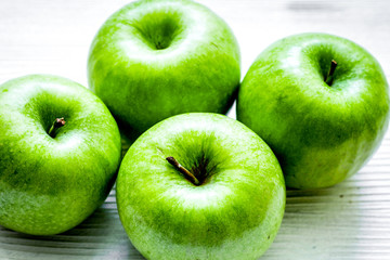 Healthy green food with apples on kitchen white background