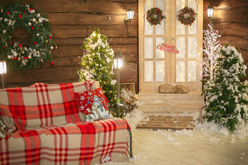 Christmas interior. Bench with plaid on the porch in winter