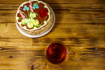 Cup of tea and Kiev cake on a wooden table. Top view