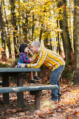 Fototapeta premium Father with daughter at park in autumn