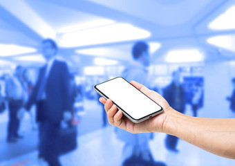 Man hand holding blank screen smartphone with blur business people on background