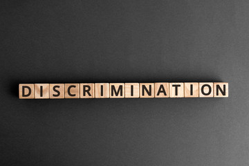 Discrimination - word from wooden blocks with letters, Human rights. Prejudice and inequality....