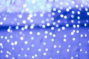 Abstract blue bokeh texture on blue black background.
