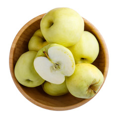Ripe  yellow apples in wooden bowl isolated on white background. Antonovka apples. Top view, close-up.