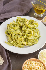 traditional Italian dish. pasta with pesto. on dark background.