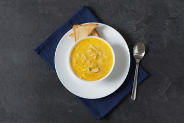 Cream cheese soup with spaghetti and chicken meat at the back background.