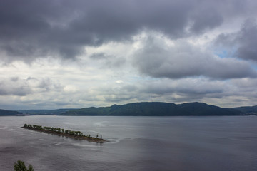 Volga river and breakwater in cloudy weather - 296115771
